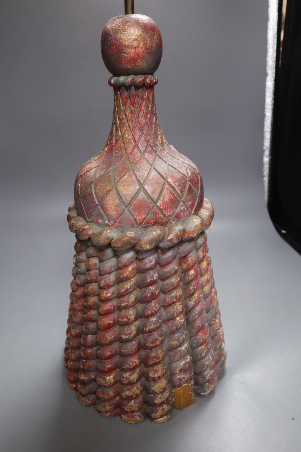 A coloured and carved wood door porter, the brass handle with clenched fist finial, height 71cm